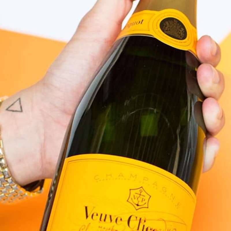 Person holding bottle of champagne, avoid champagne if you have hay fever, e-Surgery
