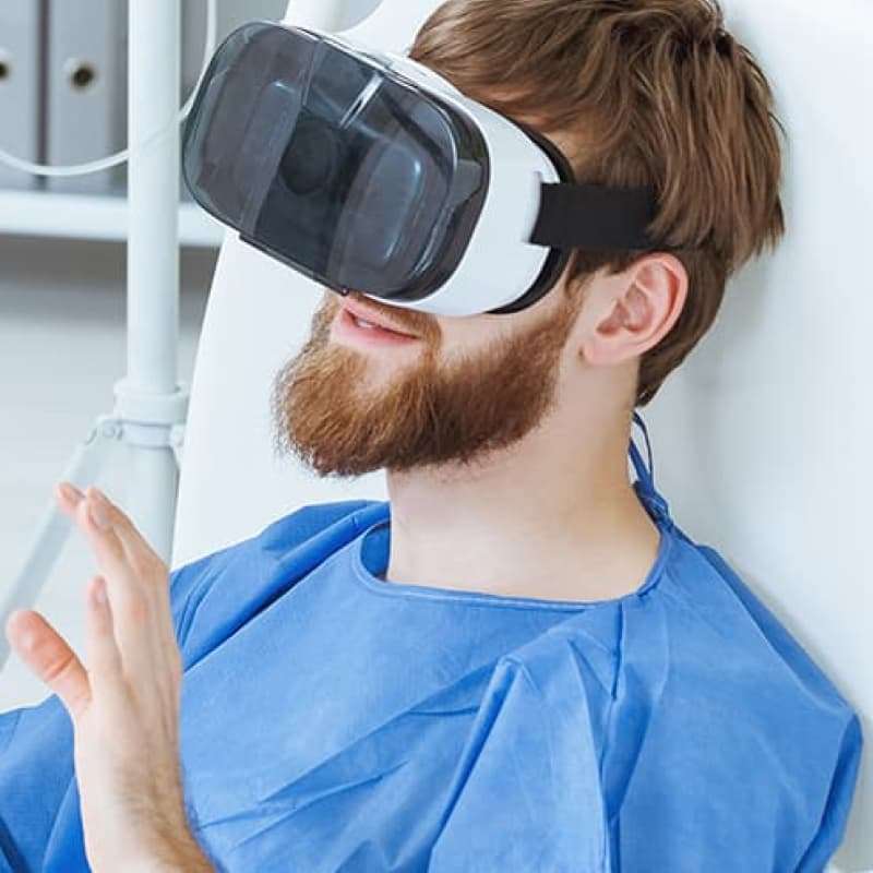 VR Healthcare, man using a VR headset in a doctors office | e-Surgery