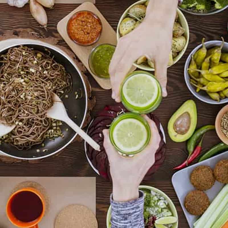 Veganuary, group of people at a table that has vegan food on it | e-Surgery