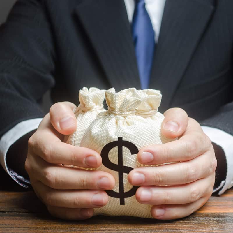 Man holding bag of money | e-Surgery
