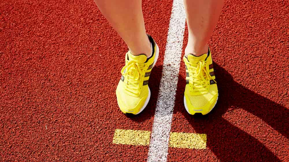 person in yellow shoes running e-surgery