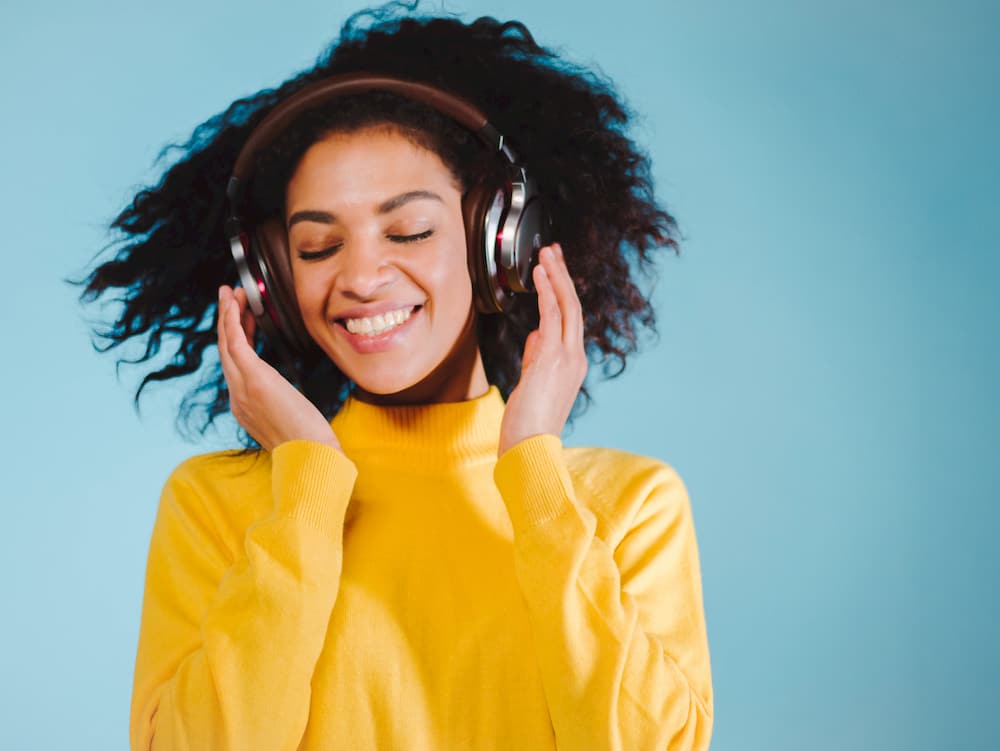 Happy woman dancing with headphones, e-Surgery