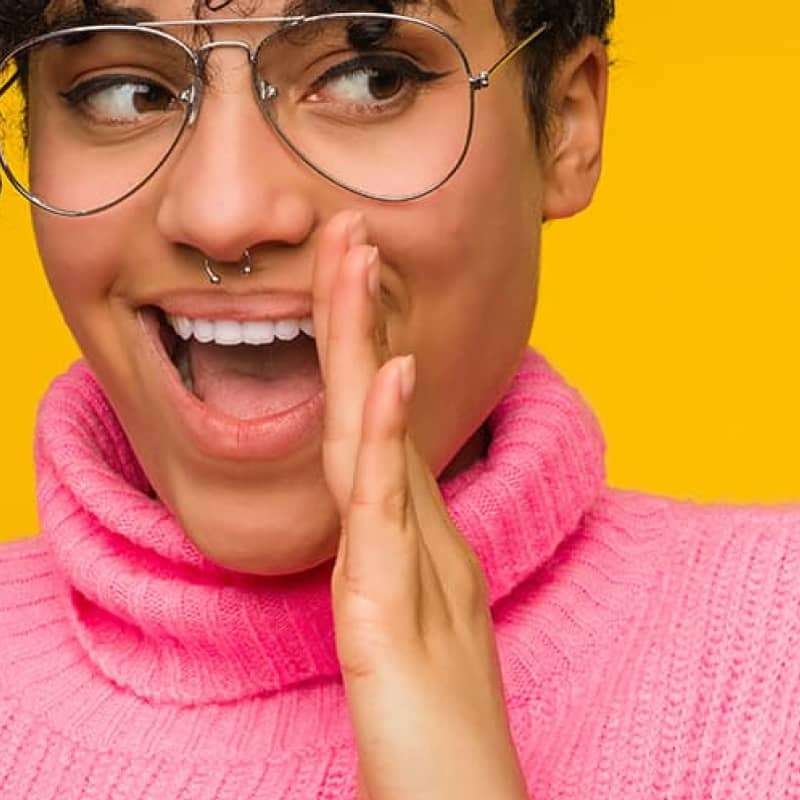 Woman with glasses and pink jumper whispering, what is bacterial vaginosis, e-Surgery