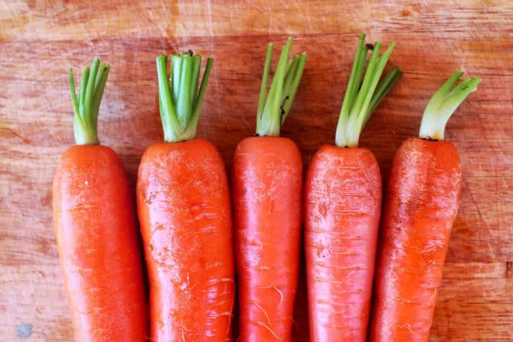 Carrots on wooden table, superfood, e-Surgery