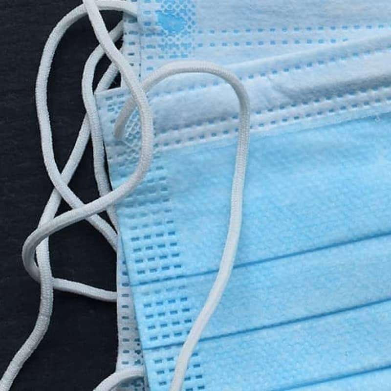 How to wear a face mask, disposable face masks on a black surface | e-Surgery