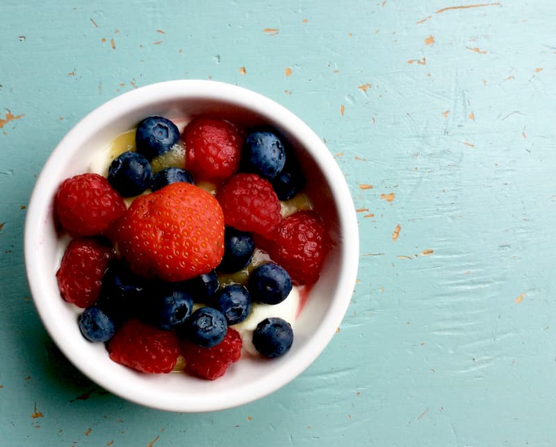 Bowl of yogurt with berries and honey on the top | The Orlistat Diet: Avoid These Foods! | e-Surgery