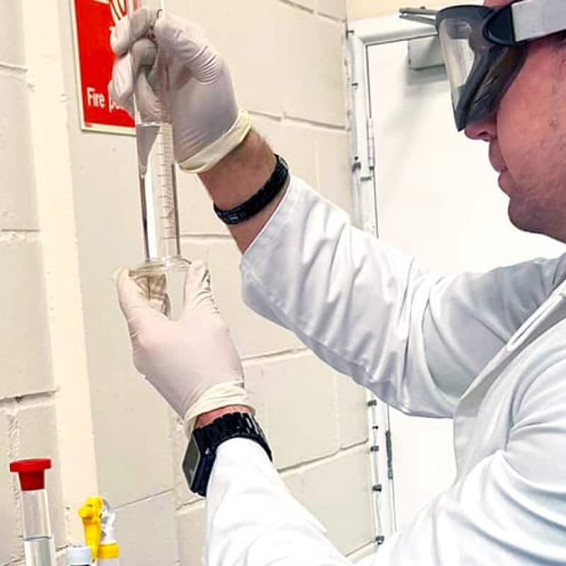 Making hand sanitiser at e-Surgery pharmacy, e-Sugery CEO in a lab coat making WHO regulated hand sanitiser