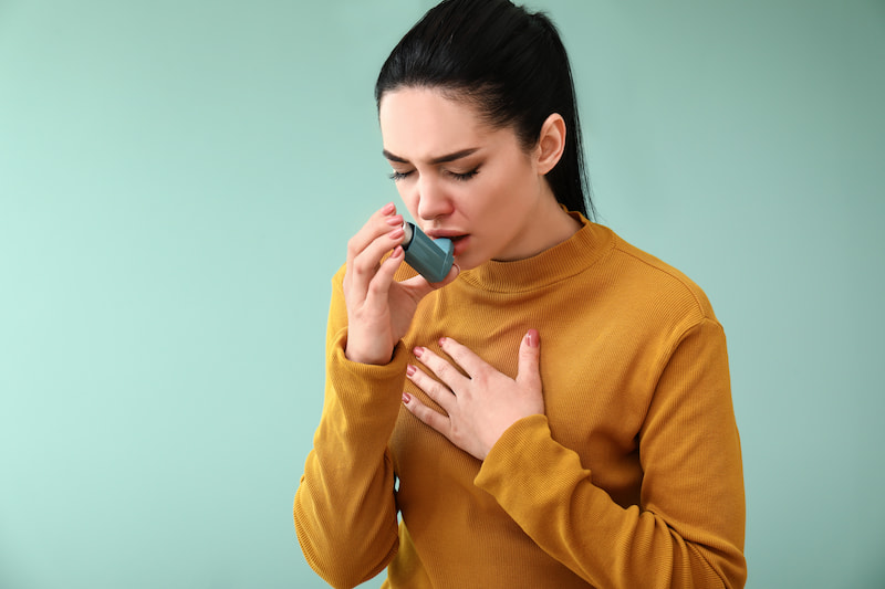 Lady using Ventolin or salbutamol inhaler | e-surgery