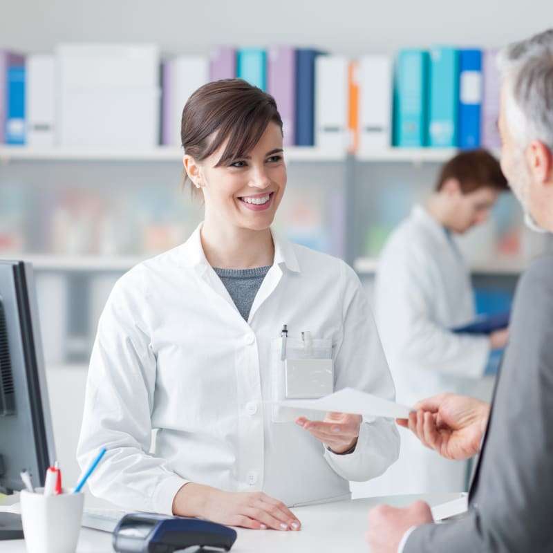 Can you buy Ramipril over the counter young woman being handed a prescription by a man in a pharmacy