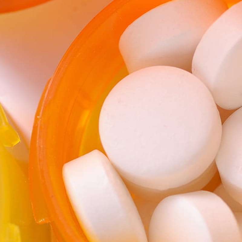 Orange bottles of medication white pills, the dangers of delaying your medication review. e-surgery