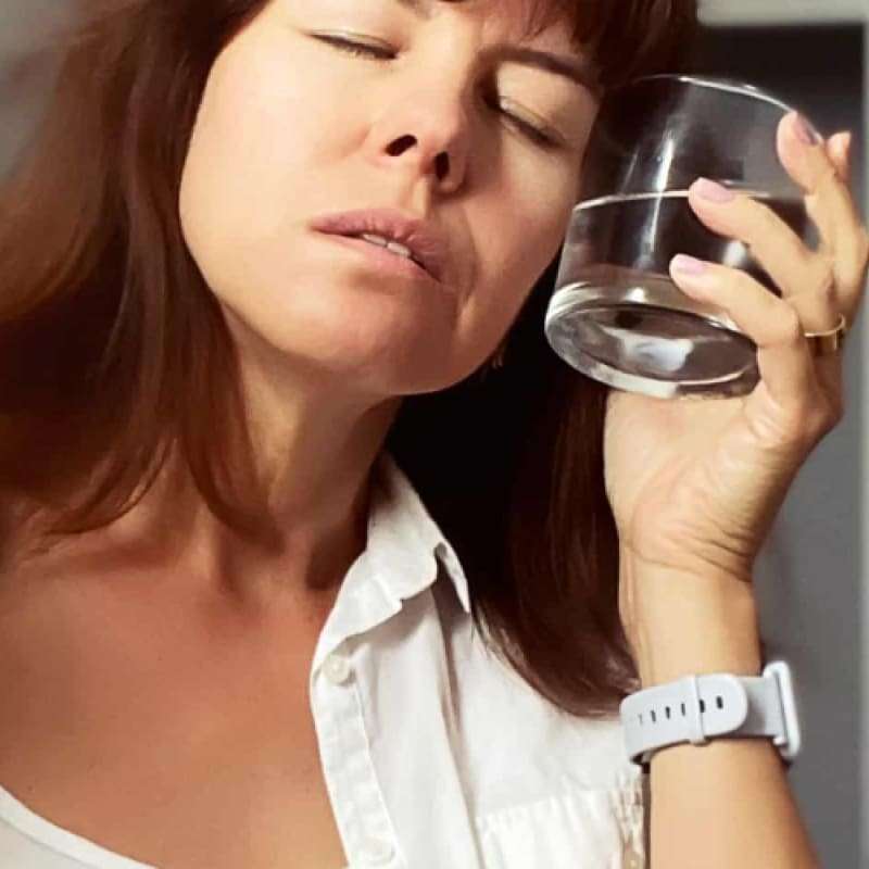 Woman cooling down as menopause is a cause of night sweats