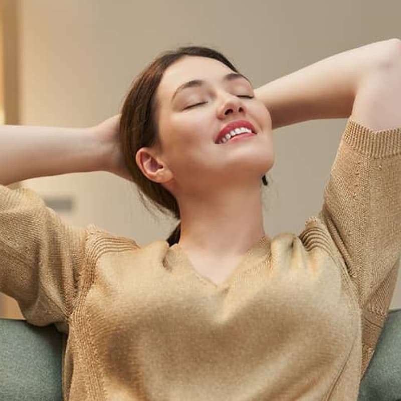 Woman holding hands behind head looking happy, common symptoms of thrush, e-Surgery