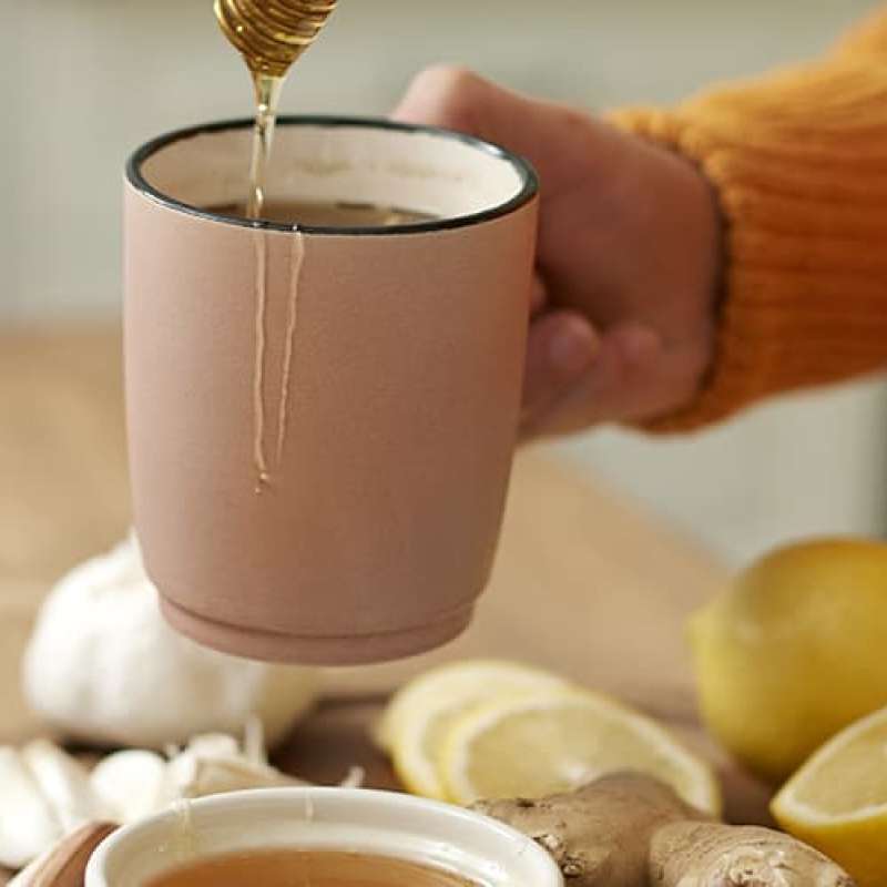 Woman making cup of tea to fight winter illness