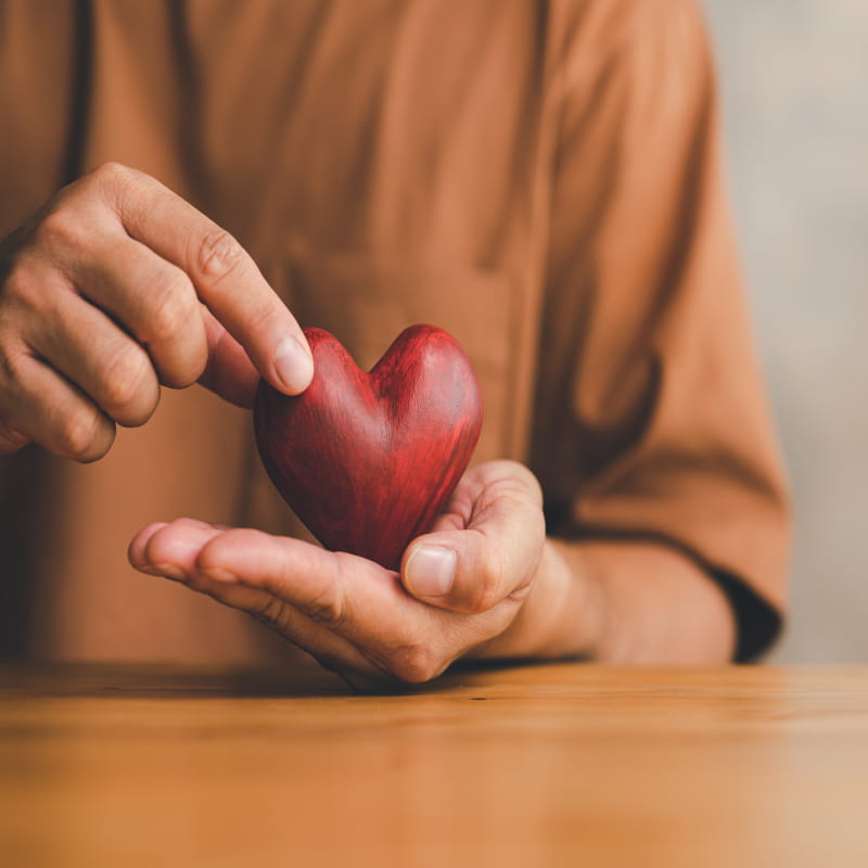 Woman holding heart for high colesterol awareness | e-Surgery