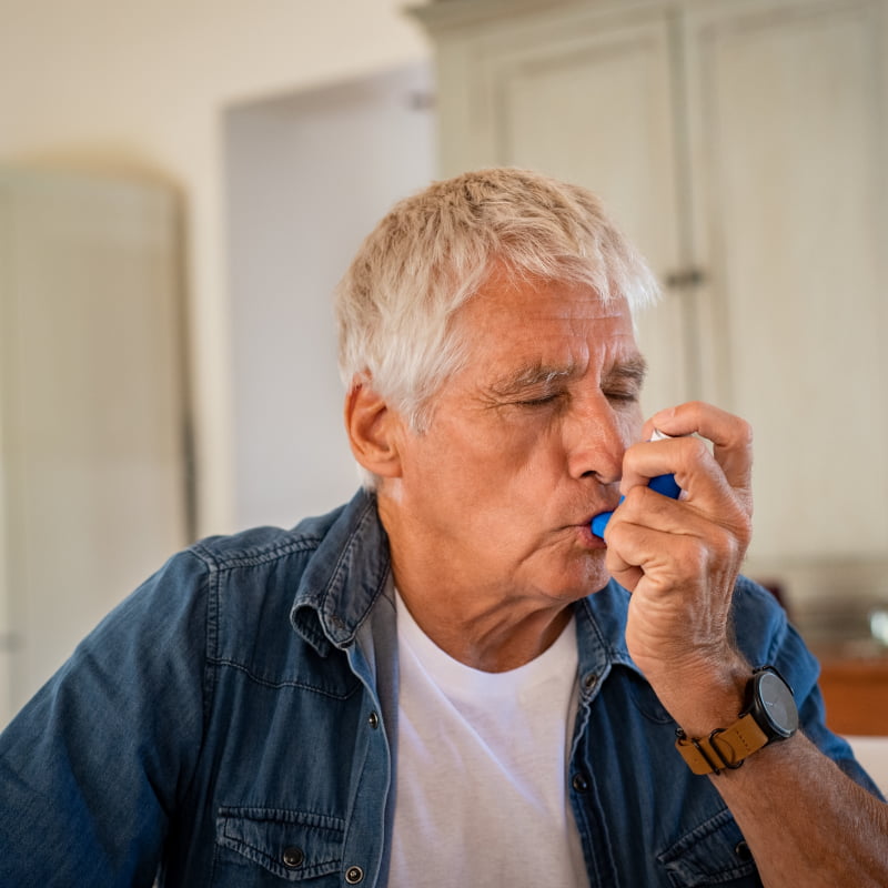 man with asthma using inhaler | e-surgery