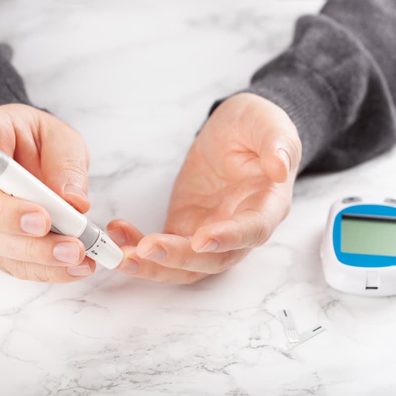 man with diabetes using lancet to check blood sugar level | e-surgery
